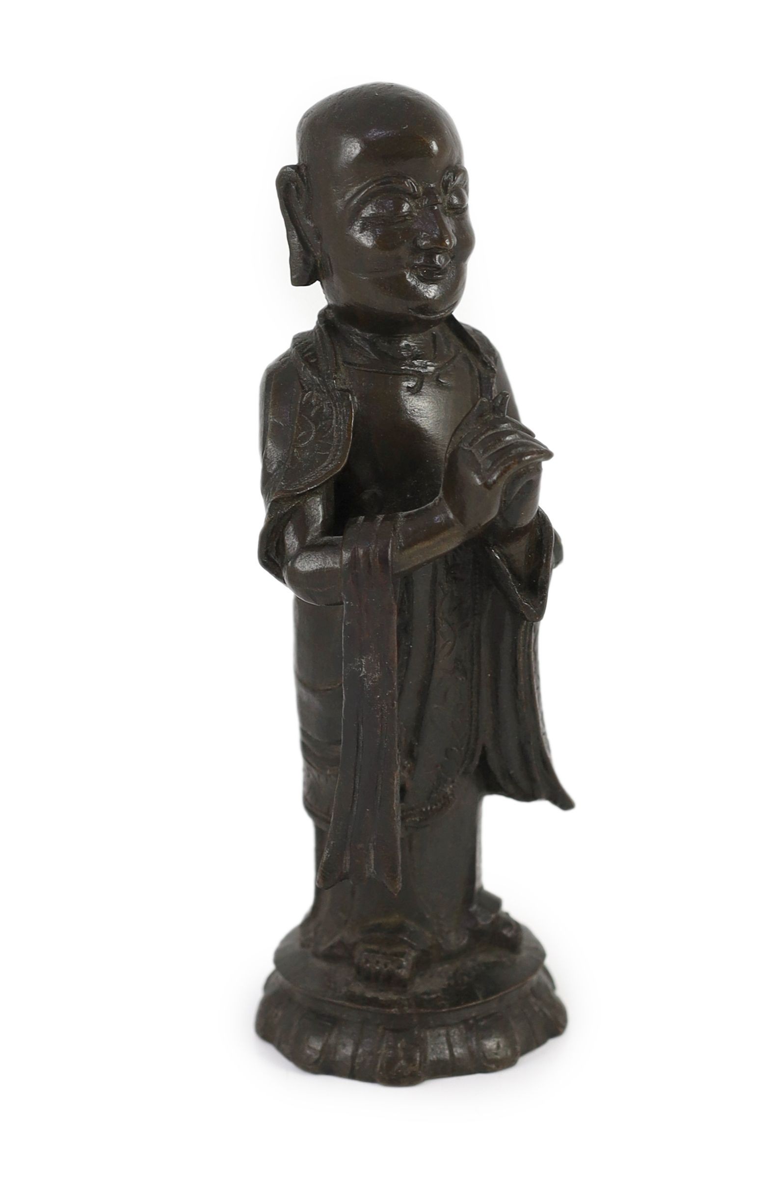 A Chinese Ming bronze figure of a luohan, 17th century, 21cm high